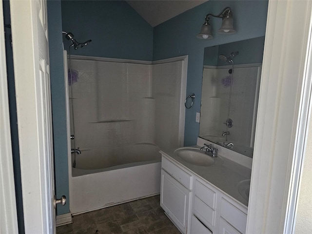 bathroom featuring bathing tub / shower combination, vaulted ceiling, and vanity