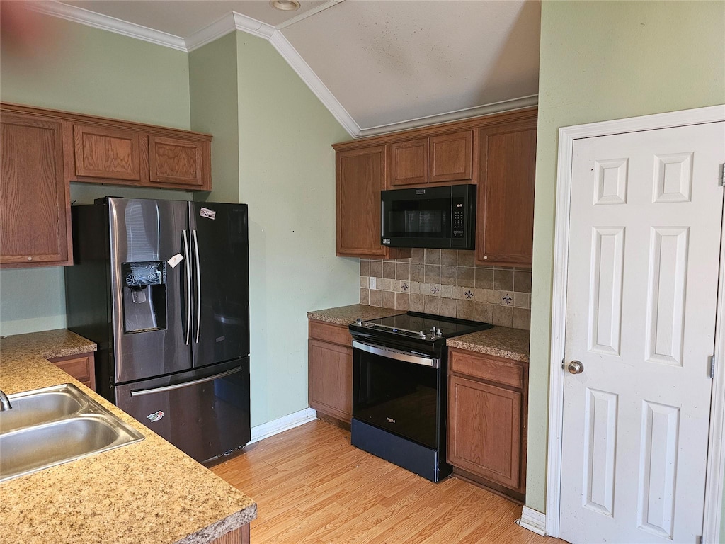 kitchen with range with electric cooktop, black microwave, backsplash, stainless steel fridge with ice dispenser, and crown molding