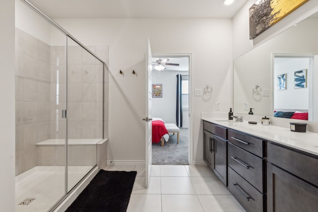 bathroom featuring walk in shower, ceiling fan, vanity, and tile patterned flooring