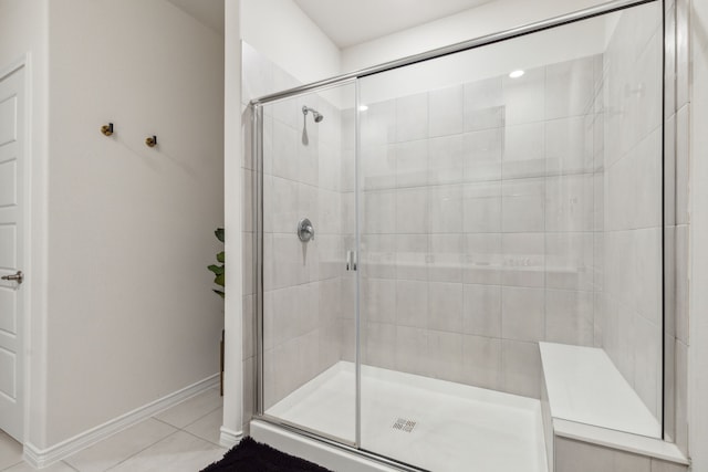 bathroom featuring an enclosed shower and tile patterned floors