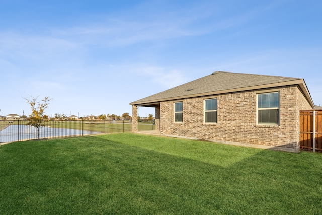 rear view of house with a yard