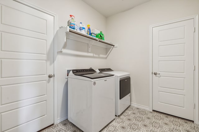 laundry area with separate washer and dryer and light tile patterned floors