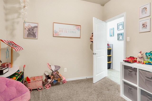 recreation room with light colored carpet