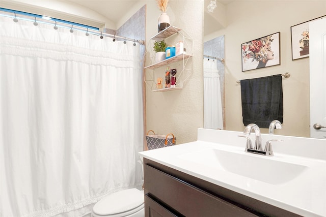 bathroom featuring a shower with curtain, vanity, and toilet