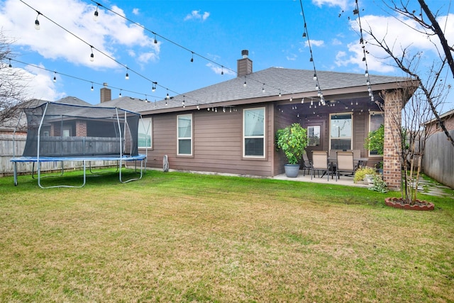 rear view of house featuring a patio and a yard