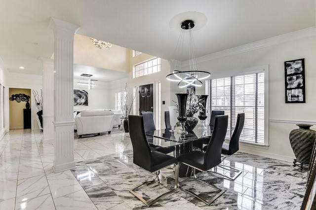 dining area featuring ornamental molding and ornate columns