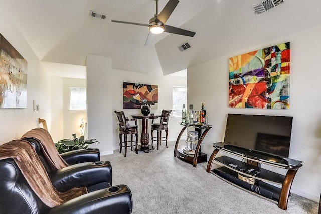 living room with ceiling fan, carpet flooring, vaulted ceiling, and a wealth of natural light