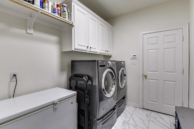 washroom with cabinets and separate washer and dryer