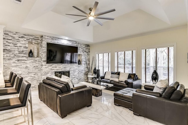 living room featuring ceiling fan and a tray ceiling