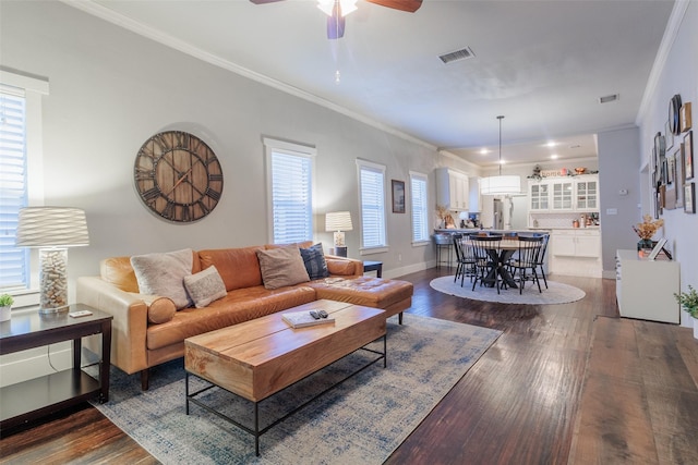 living room featuring crown molding, ceiling fan, and dark hardwood / wood-style floors