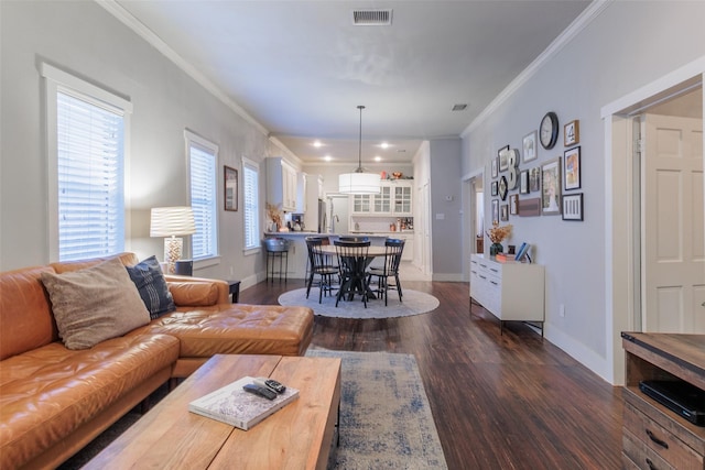 living room with ornamental molding and dark hardwood / wood-style floors