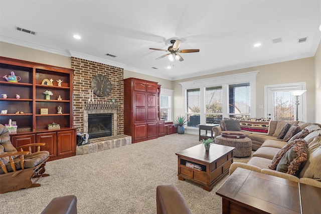 carpeted living room featuring crown molding, a brick fireplace, and ceiling fan