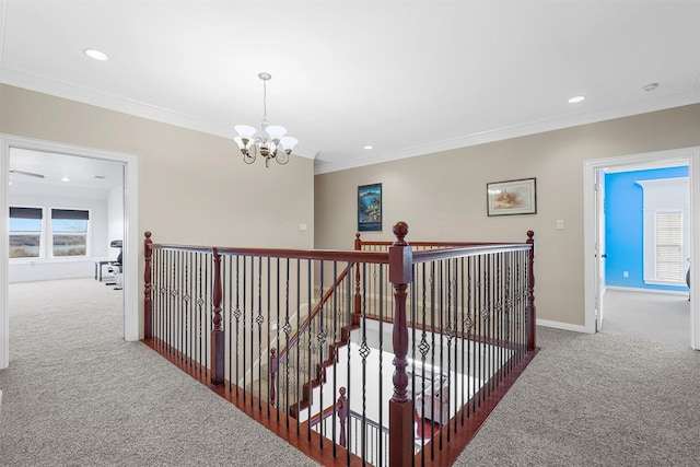 corridor with crown molding, carpet, and a notable chandelier