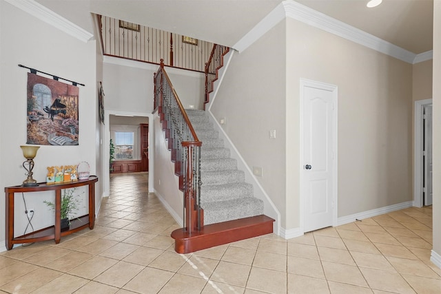 stairway featuring crown molding, a towering ceiling, and tile patterned flooring