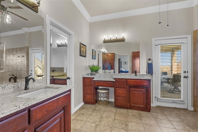 bathroom featuring crown molding, ceiling fan, and vanity