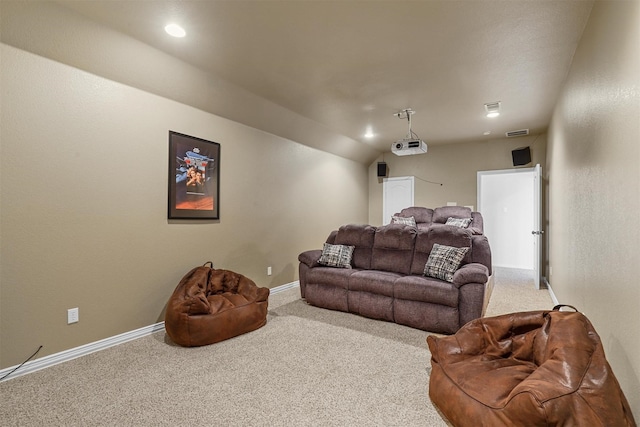 carpeted home theater room with lofted ceiling