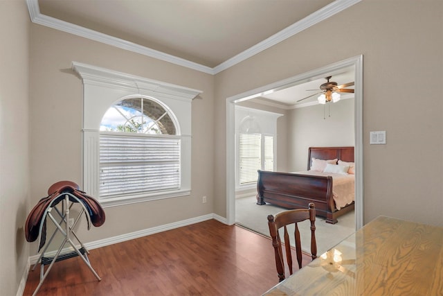 bedroom featuring hardwood / wood-style flooring, crown molding, and ceiling fan