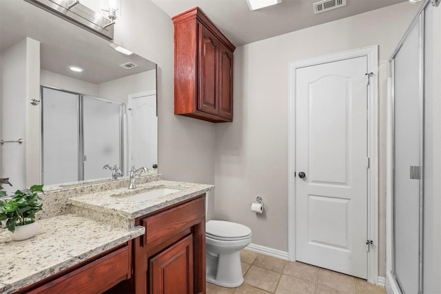 bathroom featuring walk in shower, tile patterned floors, vanity, and toilet