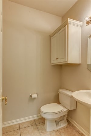 bathroom with tile patterned flooring and toilet