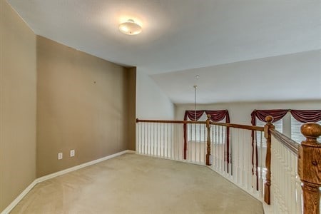 hallway with carpet floors