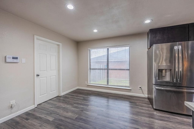 kitchen featuring dark wood-type flooring and stainless steel refrigerator with ice dispenser