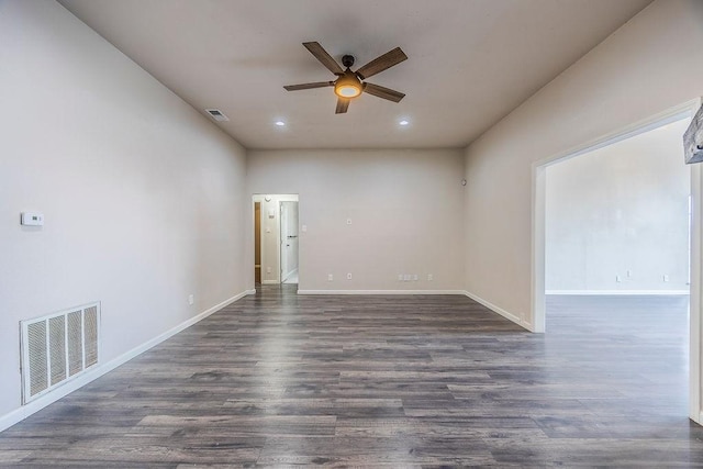 unfurnished room with ceiling fan and dark hardwood / wood-style flooring