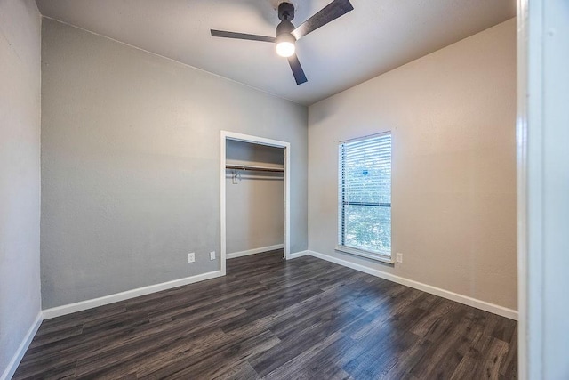 unfurnished bedroom featuring dark hardwood / wood-style flooring, a closet, and ceiling fan