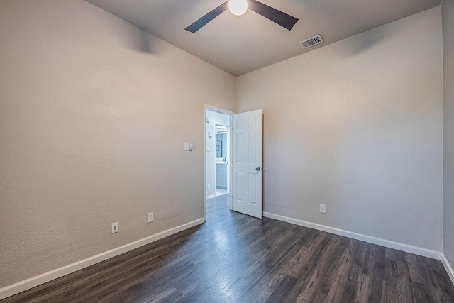 spare room with dark hardwood / wood-style floors and ceiling fan