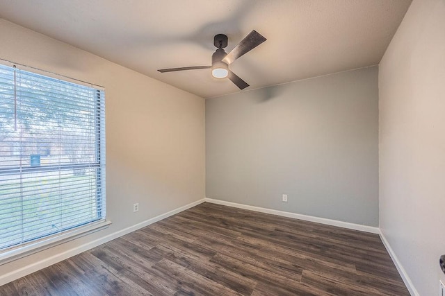 empty room featuring dark wood-type flooring and ceiling fan