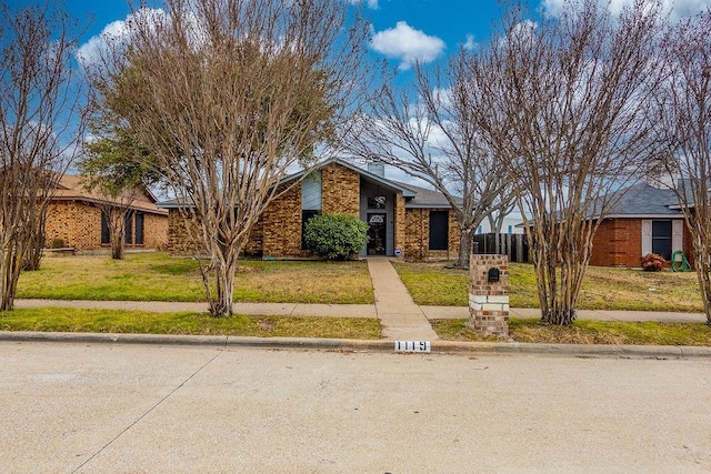 ranch-style home with a front lawn