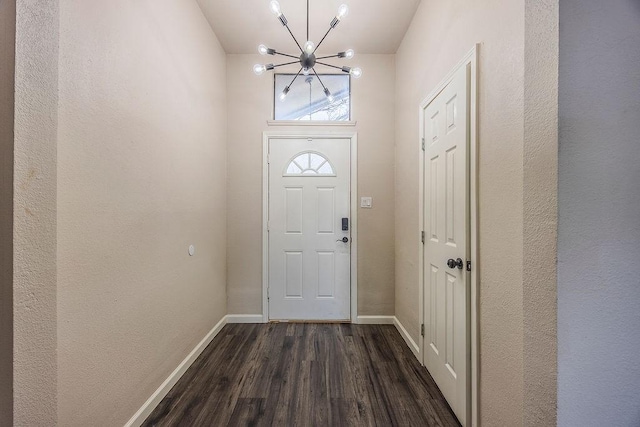 entryway featuring dark hardwood / wood-style floors and a notable chandelier