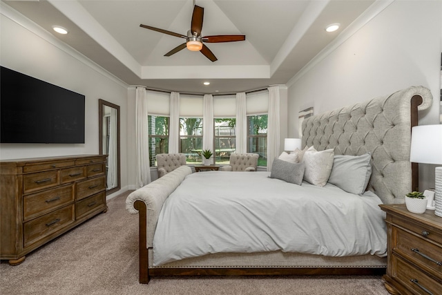 carpeted bedroom featuring crown molding, ceiling fan, and a tray ceiling