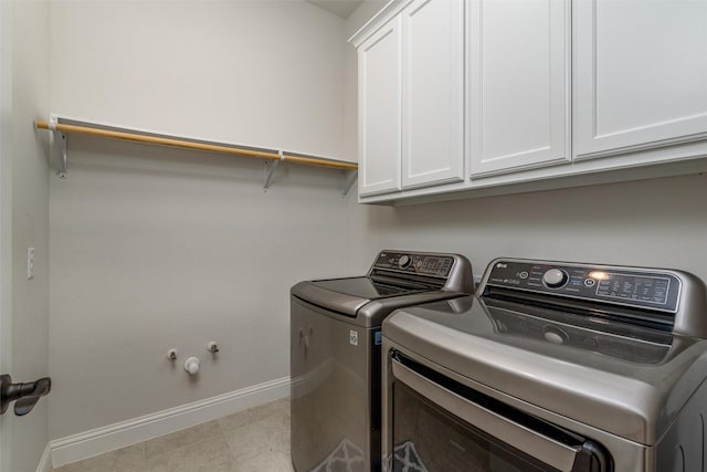 washroom featuring cabinets and independent washer and dryer