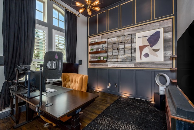 office area with an inviting chandelier and dark hardwood / wood-style flooring