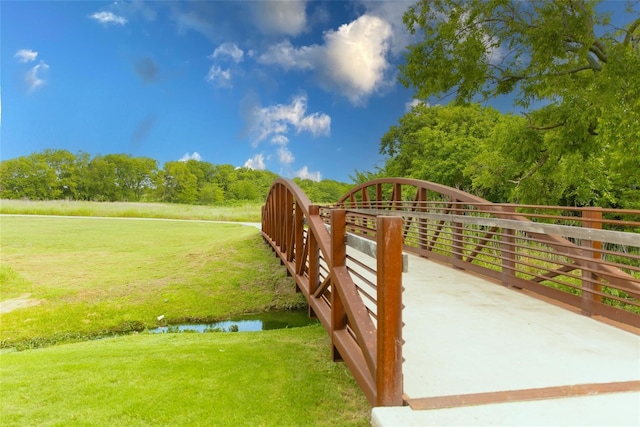 exterior space featuring a lawn and a water view