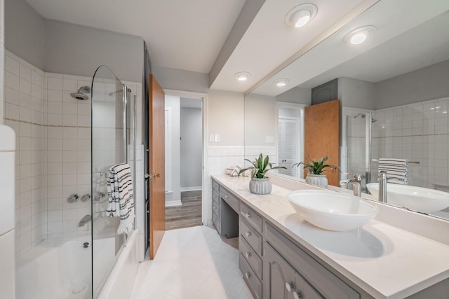 bathroom featuring vanity and bath / shower combo with glass door