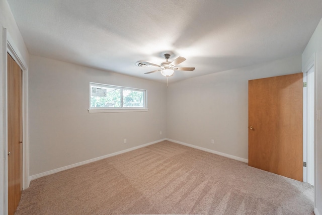 unfurnished bedroom featuring a closet, ceiling fan, and carpet flooring