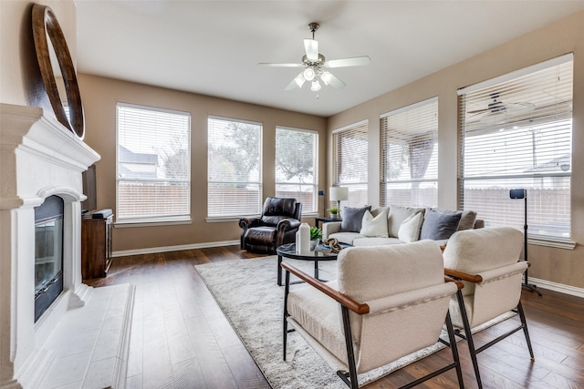 living room featuring ceiling fan and dark hardwood / wood-style flooring