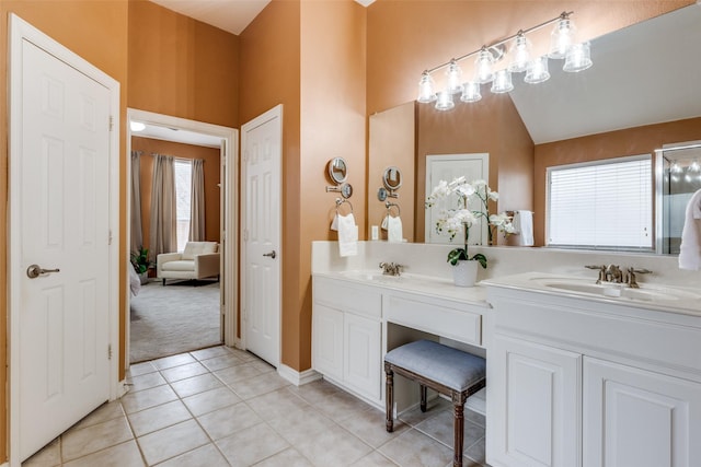 bathroom featuring vanity, tile patterned flooring, and lofted ceiling