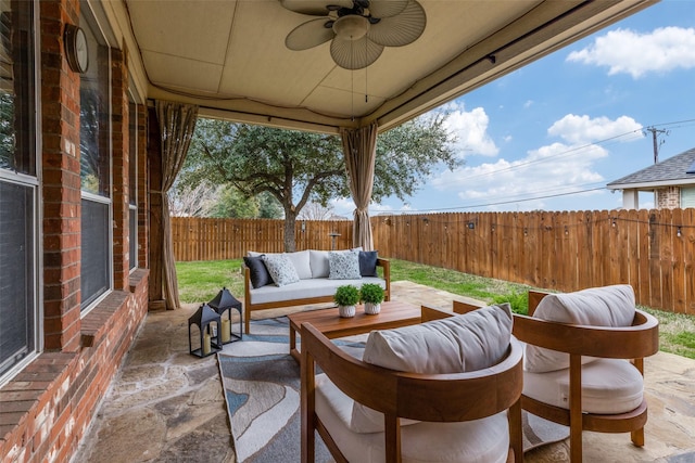 view of patio with an outdoor living space and ceiling fan