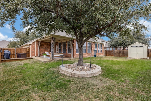 view of yard featuring a shed and a patio area