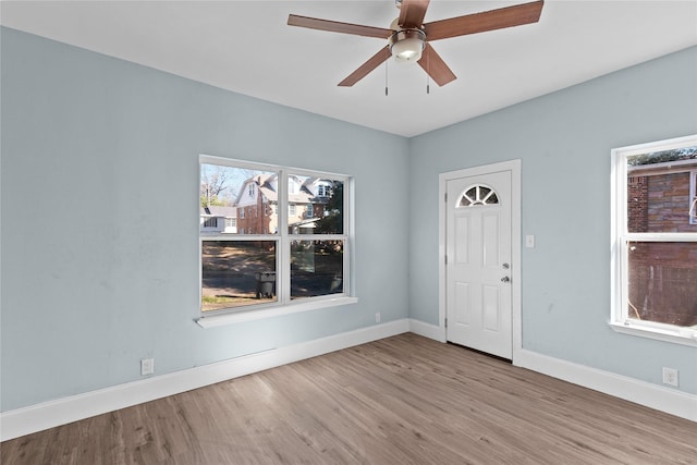 spare room with ceiling fan and light wood-type flooring