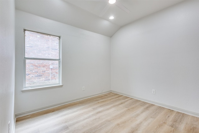 unfurnished room with lofted ceiling, ceiling fan, and light wood-type flooring