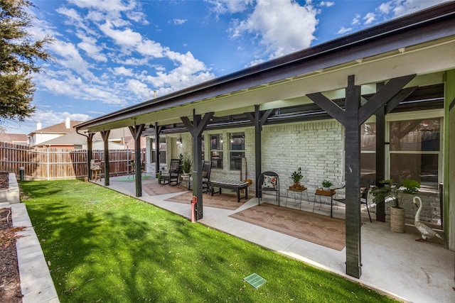 back of property with a yard and a patio area