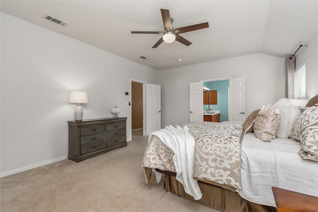 carpeted bedroom with ceiling fan, lofted ceiling, and ensuite bathroom