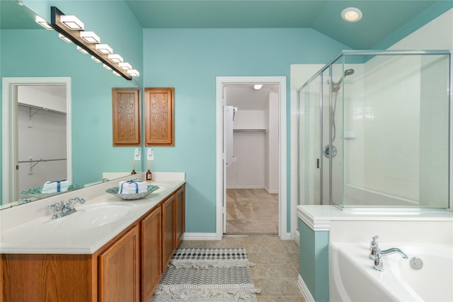 bathroom featuring independent shower and bath, vanity, vaulted ceiling, and tile patterned floors