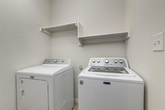 laundry room with washing machine and clothes dryer