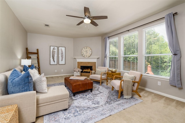 living room featuring ceiling fan, a healthy amount of sunlight, and light carpet