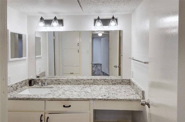 bathroom featuring vanity and a textured ceiling