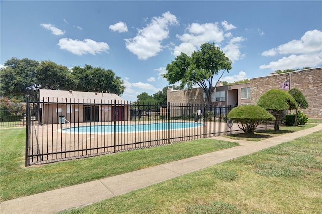 view of pool featuring a yard and a patio